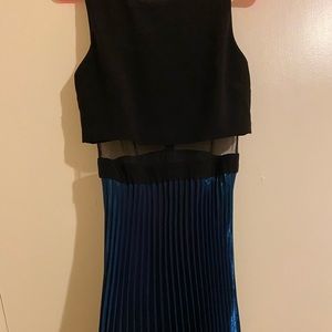 Black crop top with mesh material and flowy teal bottom. Very flattering!